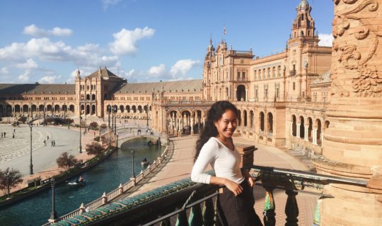 intern in seville standing in front of famous monument